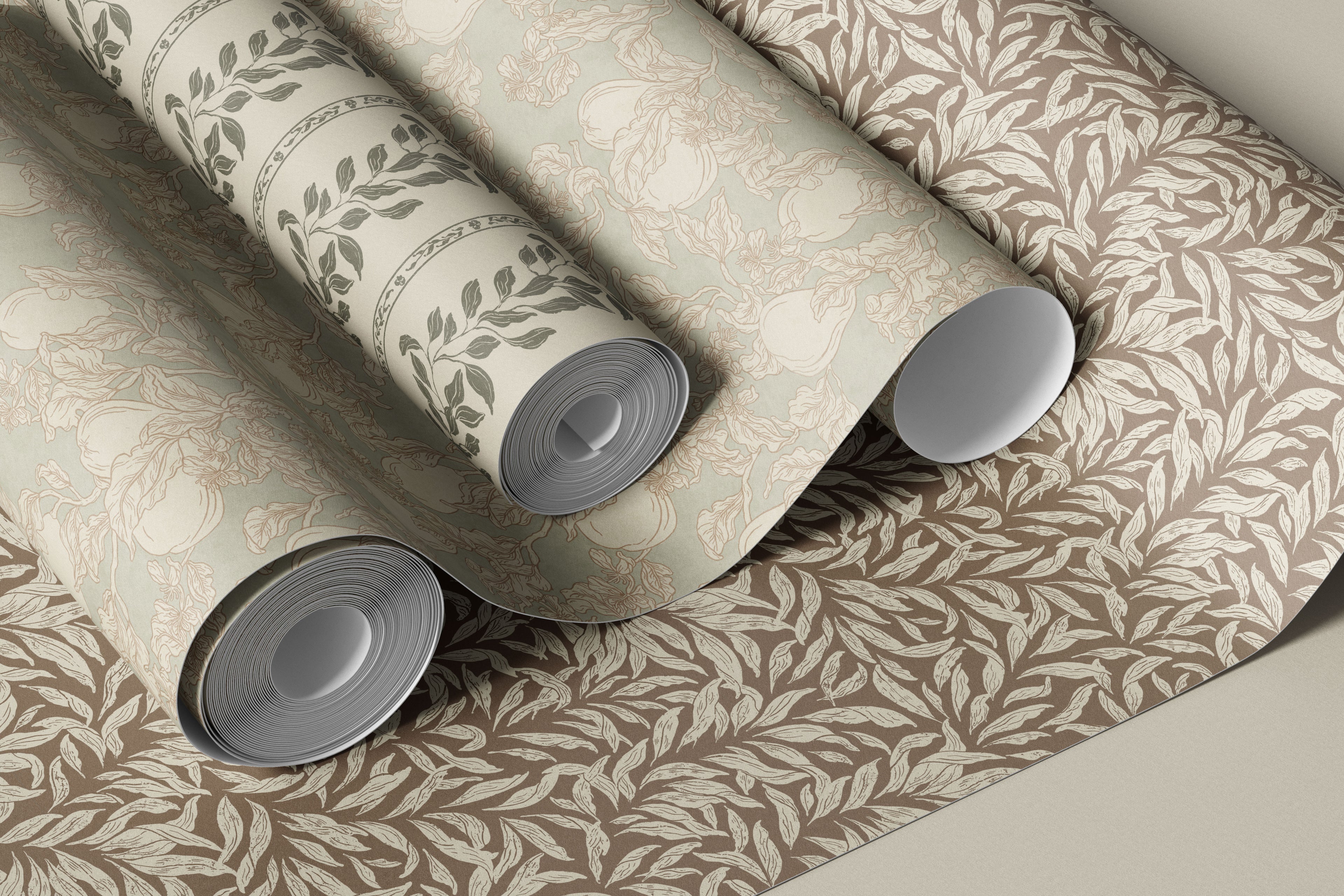 Three rolls of wallpaper with leaf pattern on a neutral background
